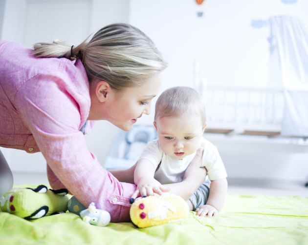 Teenage girl playing with baby boy