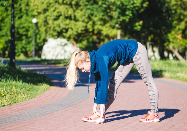 Fitness woman doing exercises during outdoor cross training workout in