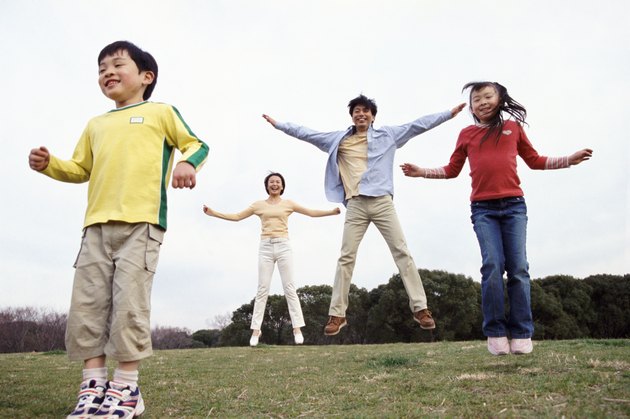 Family Jumping in a Park