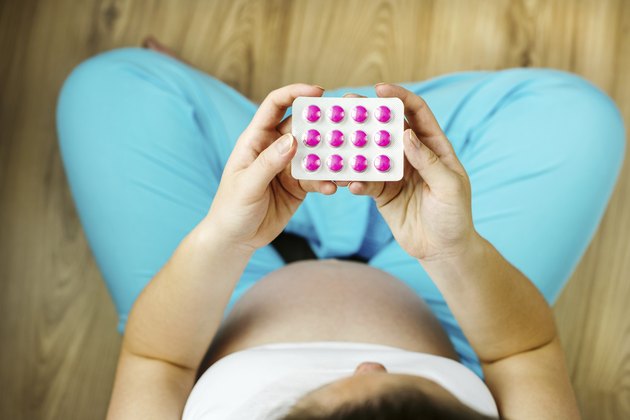 Pregnant woman with pills