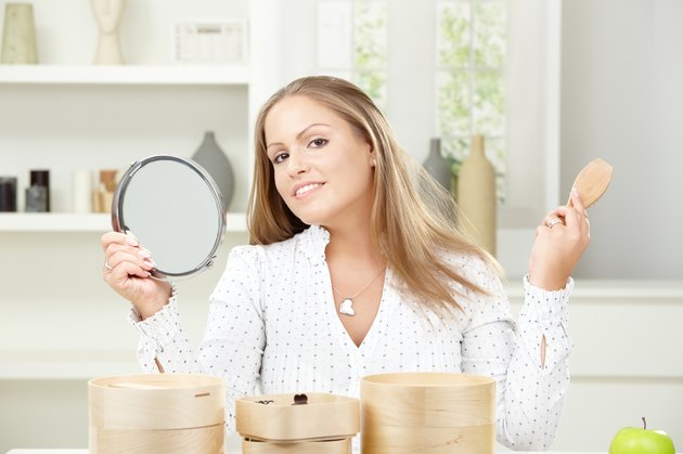 Young woman brushing hair