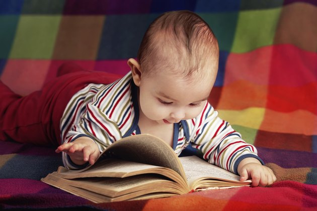 cute little baby reading book