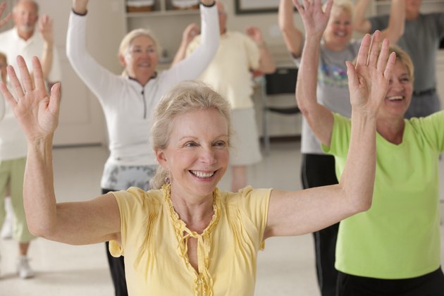 Seniors exercising with arm stretches