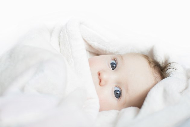Funny baby playing peek-a-boo