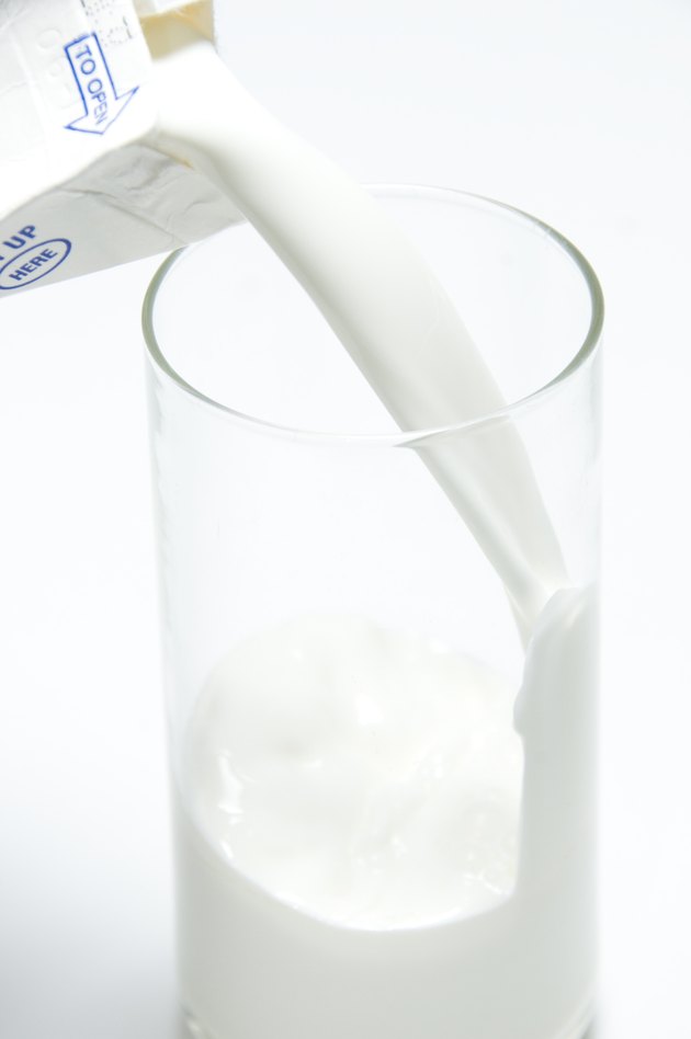 Pouring a Glass of Milk from Carton