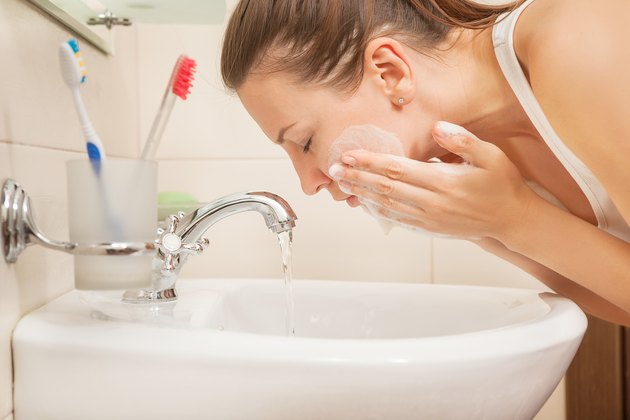 young woman washing face