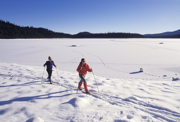 Two people skiing in a ski resort