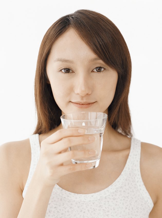 Woman Holding a Glass of Water