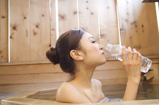 Woman drinking water in a hot tub