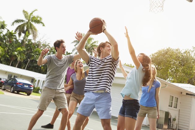 Group Of Young Friends Playing Basketball Match