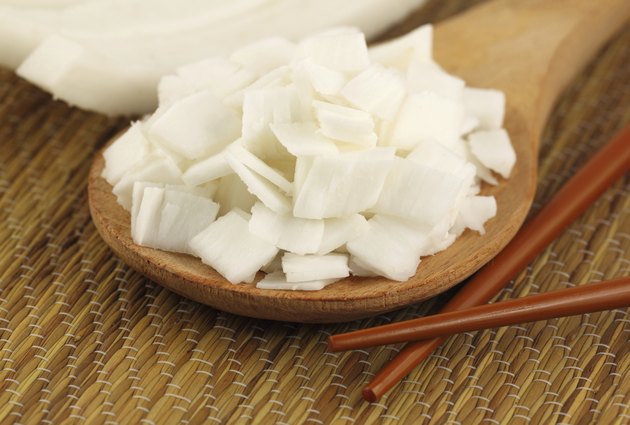 Sliced coconut with chopstick