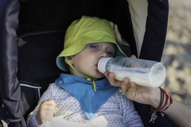 Baby drinks milk from a bottle