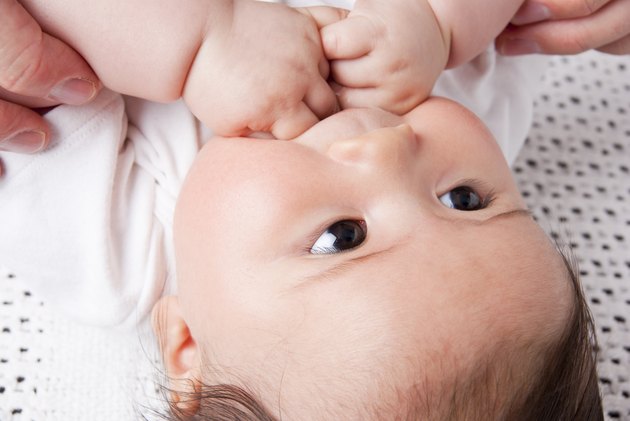 Asian baby girl in parent's care