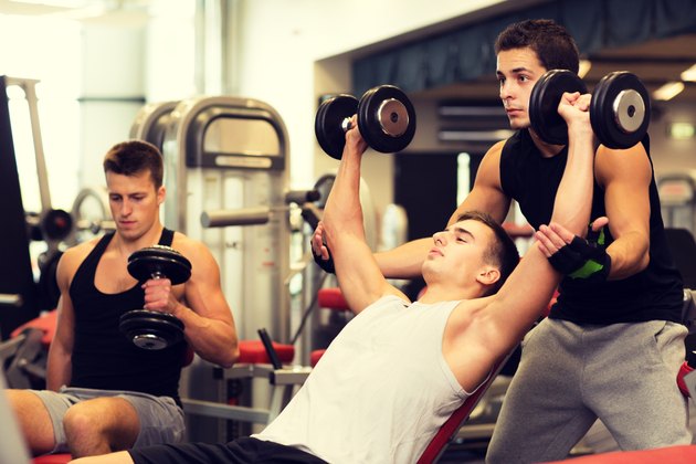 group of men with dumbbells in gym