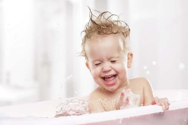 happy funny baby laughing and bathed in bath