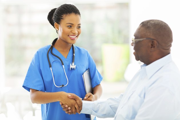 african american medical nurse handshaking with senior patient