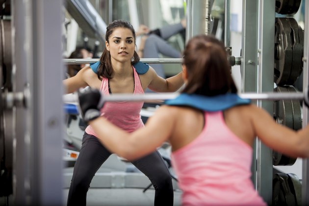 Doing squats with a barbell