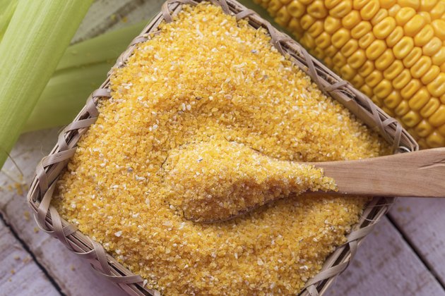Corn meal on wooden background