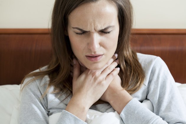 Woman having a sore throat