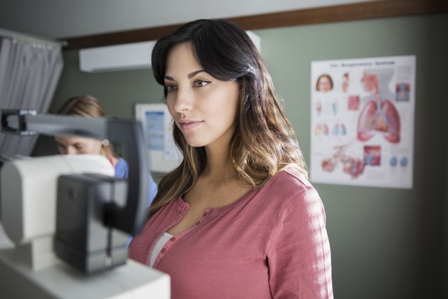 Woman on weight scale in examination room