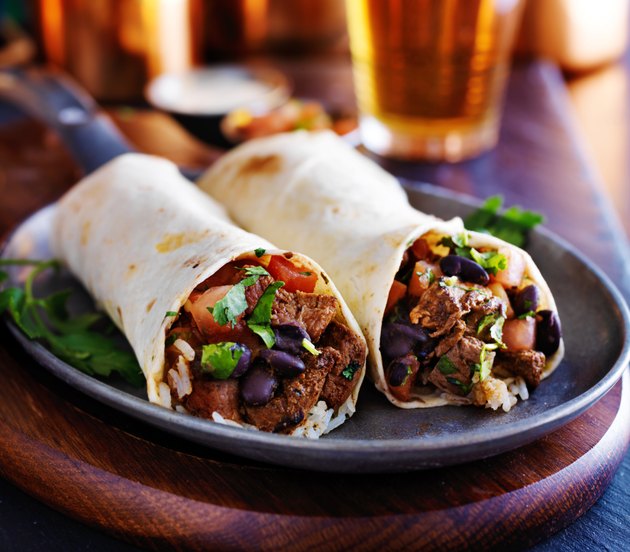 two beef steak burritos