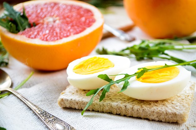 Healthy breakfast with eggs, grapefruit and fresh arugula