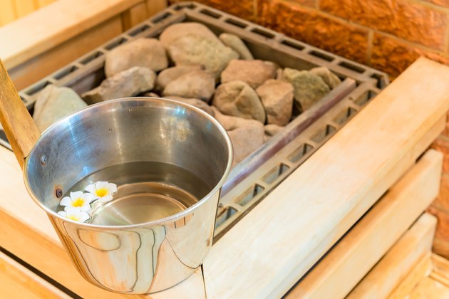 water with floating flowers and stones in the sauna