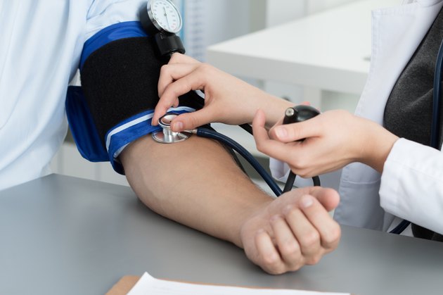 Female medicine doctor measuring blood pressure to patient