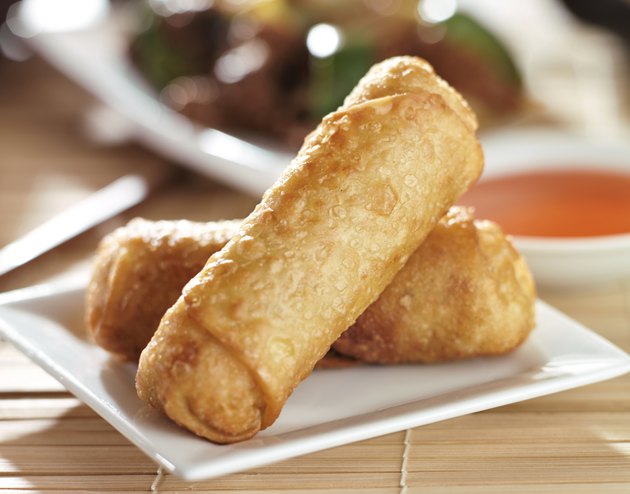 chinese egg rolls with sauce on plate