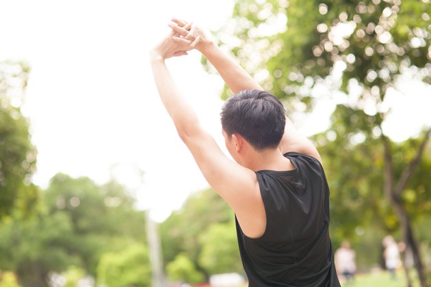 Athletic stretching in the morning and watching nice nature view