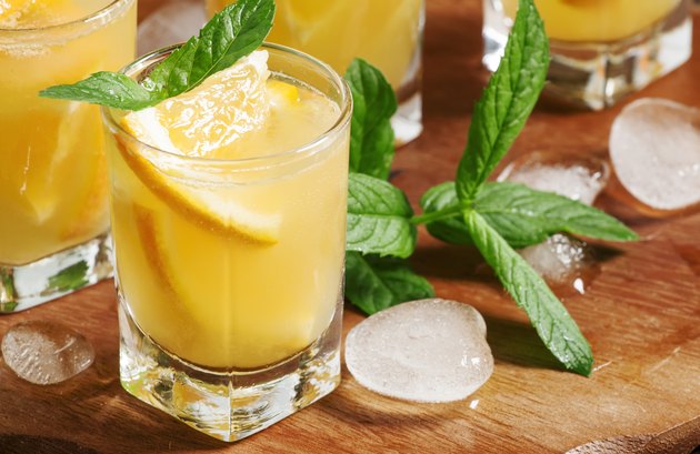 Refreshing cocktail with soda, orange, mint and ice