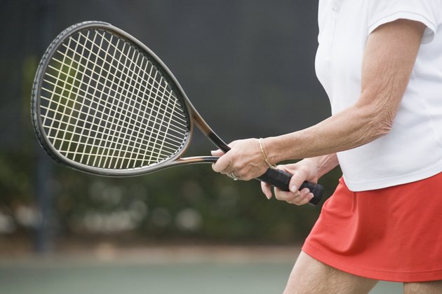 Mid section view of a senior woman playing tennis