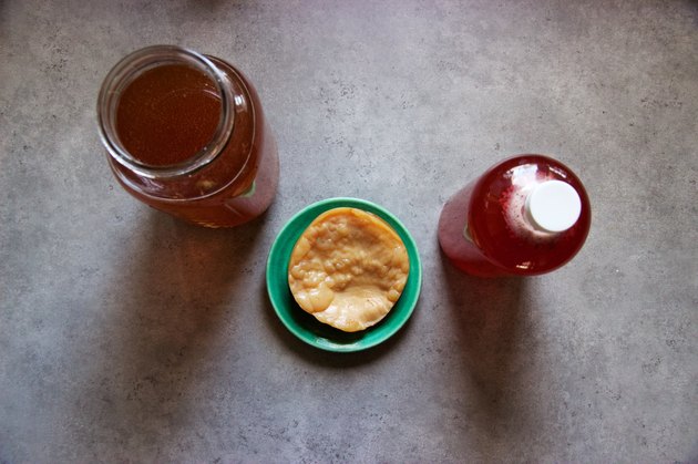 Homemade kombucha: fermented tea brewing, mother, bottled with raspberry