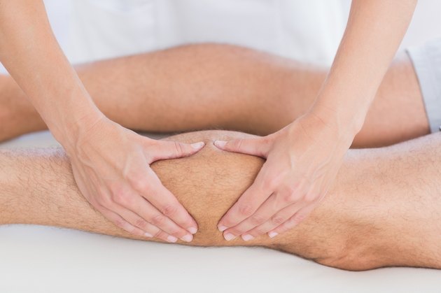 Physiotherapist doing calf massage to her patient