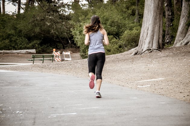 Young woman running on trail