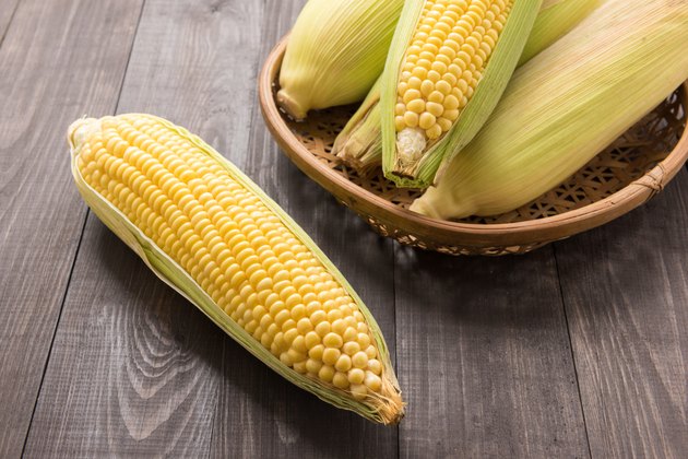 Fresh organic yellow sweet corn on wooden table