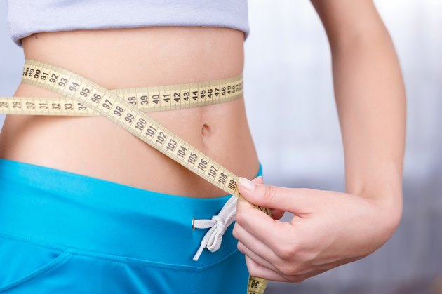 Woman measuring waist line