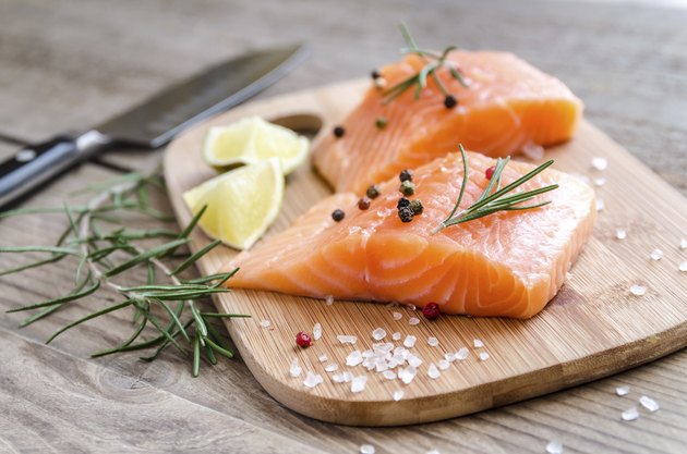 Raw salmon steaks on the wooden board
