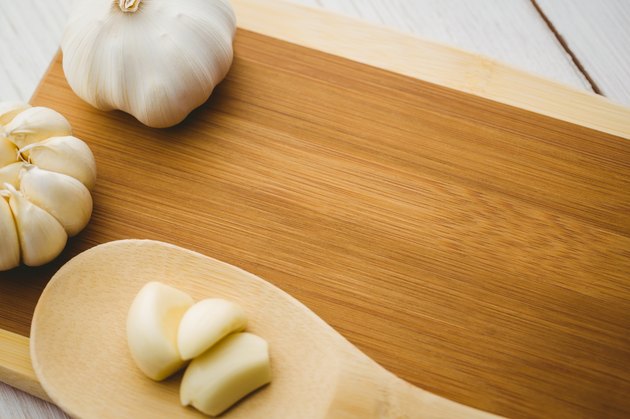 Garlic cloves and bulb on chopping board