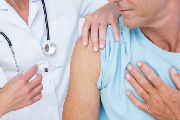 Doctor doing an injection to her patient