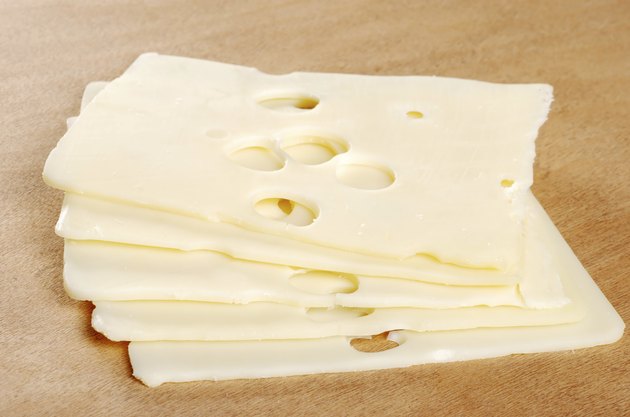 swiss cheese on wood cutting board