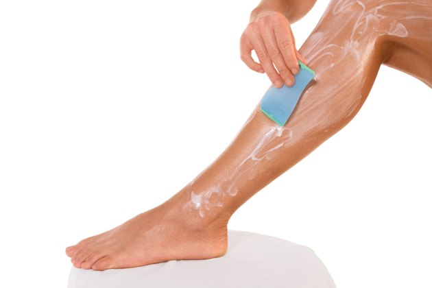 Shaving - woman removing leg hair (close up)