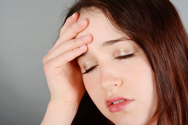 Young woman having head ache