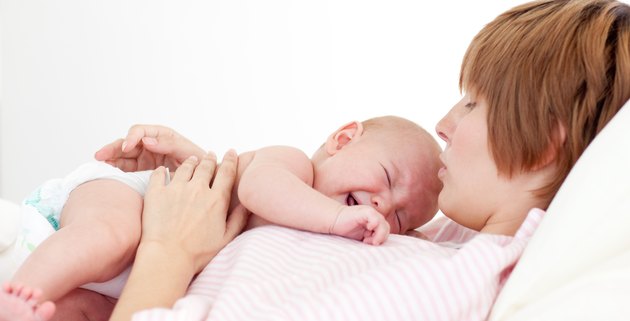 Mother playing with her baby son