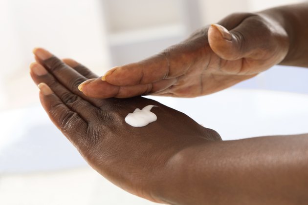 female hand applying moisturiser
