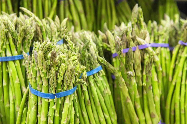 bunch of fresh asparagus from market shelves real