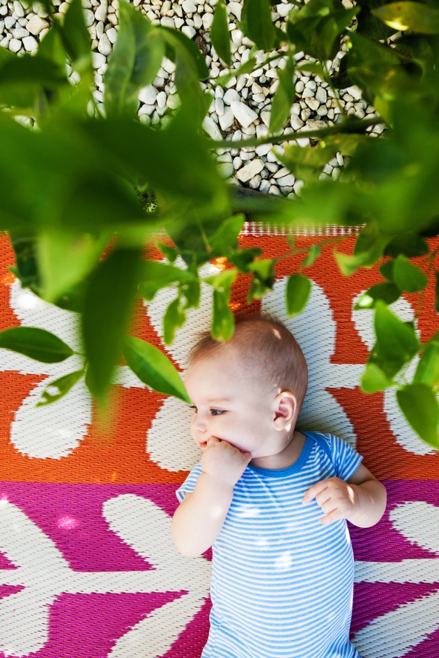 Baby Boy is Lying Down in the Backyard