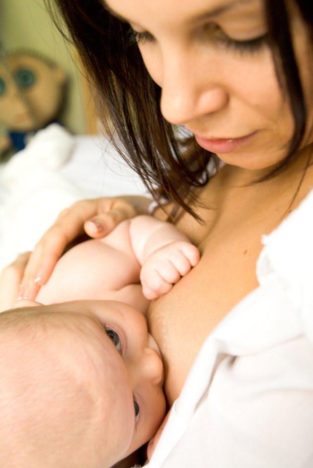 Young woman breastfeeding a baby