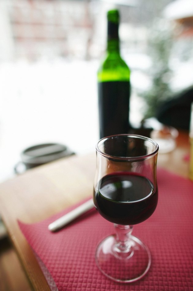Close up view of table with bottle of wine and wineglass, Val d'Isere, the French Alps