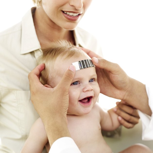 doctor taking a baby's temperature